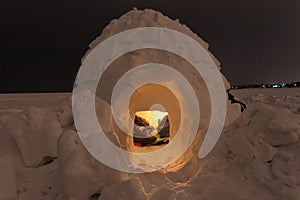 Snow igloo on the frozen sea on a background of the night