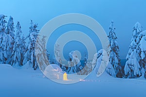 Snow igloo luminous from the inside