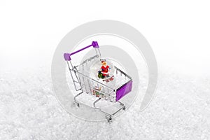 Snow on iÃÂ§inde Christmas water globe with Santa Claus shopping cart, on white background. photo