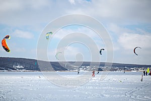 Snow kiting on a snowboard on a frozen lake