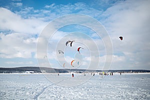 Snow kiting on a snowboard on a frozen lake