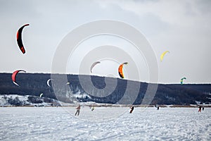 Snow kiting on a snowboard on a frozen lake