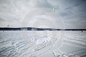 Snow kiting on a snowboard on a frozen lake