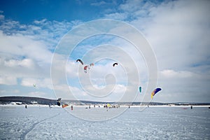 Snow kiting on a snowboard on a frozen lake