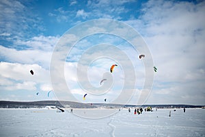 Snow kiting on a snowboard on a frozen lake