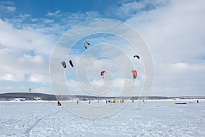 Snow kiting on a snowboard on a frozen lake