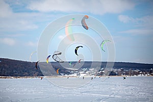 Snow kiting on a snowboard on a frozen lake