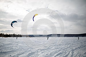 Snow kiting on a snowboard on a frozen lake