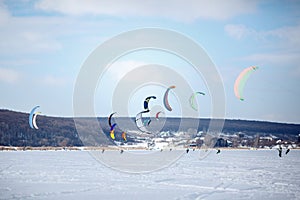 Snow kiting on a snowboard on a frozen lake