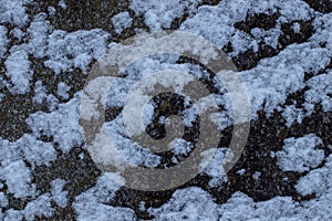 Snow lieing on a stone. Ice growing on stone.