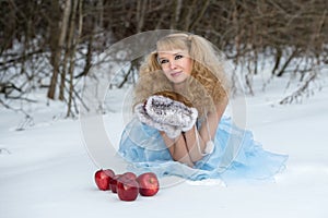 Snow Maiden in a winter forest with apples