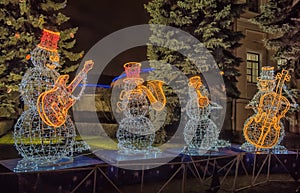 Snow man decorated with garland