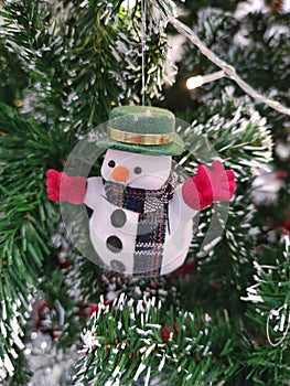 Snow man doll decorated on Christmas tree.