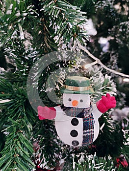 Snow man doll decorated on Christmas tree.