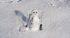Snow man. Happy snowman on snow, funny winter time. Repairman with wrench and screwdriver. Support repair and recover