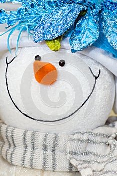 Snow man toy with glamour scarf.