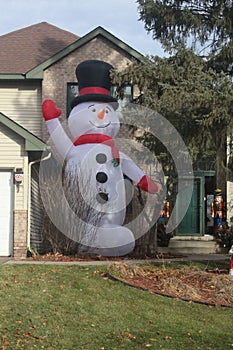 Snow Man Two Stories Tall Outside a House