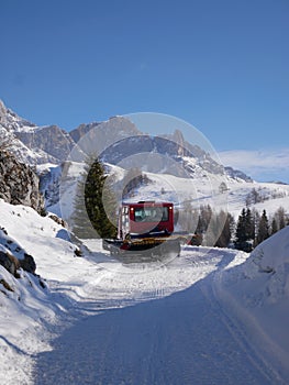 Snow mobile on italian Dolomites mountains - snowy winter day