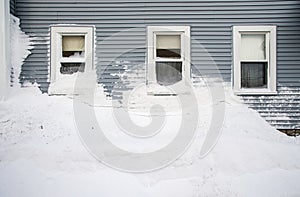 Snow mound under three windows
