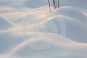 Snow mounds. Erotic snow dunes in the Ukrainian snowy woods evening with soft warm light of sunset Klevan Ukraine.