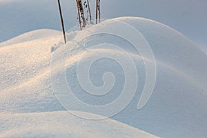 Snow mounds. Erotic snow dunes in the Ukrainian snowy woods evening with soft warm light of sunset Klevan Ukraine.