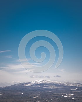 Snow on Mount Monadnock under a blue sky photo