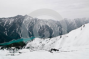 Snow mountain and Kurobe dam lake in Tateyama Kurobe Alpine Rout