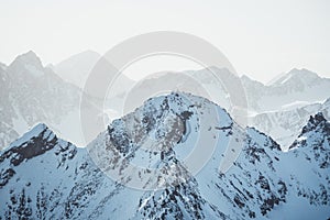 Snow mountain landscape with a sommet with mountaineers around a cross