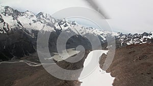 Snow mountain panorama view from helicopter window in New Zealand.