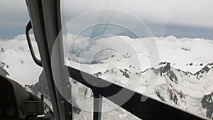Snow mountain panorama view from helicopter window in New Zealand.