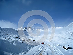 Snow mountain with red car