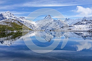 The snow mountain with reflection in lake and clear blue sky in Switzerland