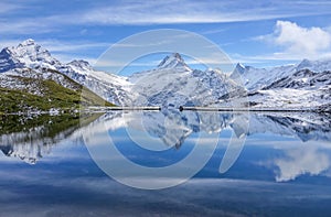The snow mountain with reflection in lake and clear blue sky in Switzerland photo