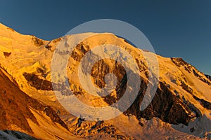 Snow mountain ridge in Alps at sunset