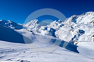 Snow mountain, ski track, footprints on snow with tiny signpost