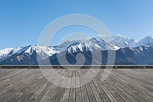 Snow mountain with wooden floor