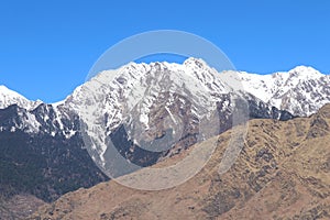 Snow on the Mountains Peak and Blue Sky and tree in India