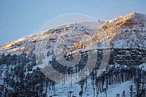 Snow mountains at sunset with fog