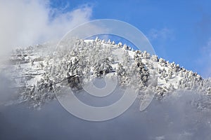 Snow mountains at sunset with fog