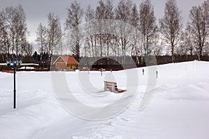 Snow park with benches and lanterns