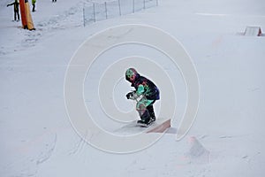 Snow park box tricks. Snowboarder in the park on a box. Winter jibbing in snwopark in italyian dolomites