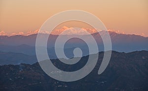 Snow peaked himalayas during sunset