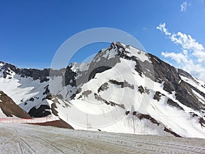 Snow peaks of the mountains and blue sky