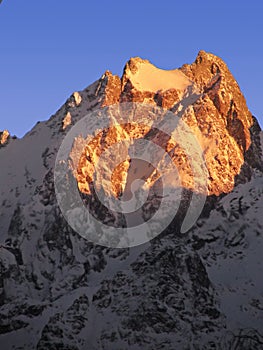Snow peaks at sunset Caucasus Chegetkara Mt