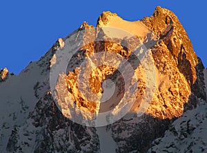 Snow peaks at sunset Caucasus Chegetkara Mt