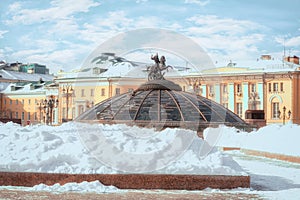 Snow pile at Manege Square. Glass cupola crowned by a statue of Saint George, holy patron of Moscow.