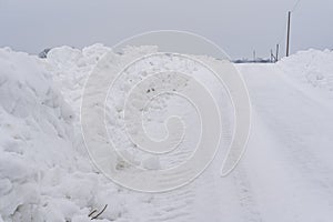 Snow Piles Along Slippery Rural Road