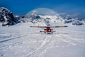 A Snow Plane Landing in a Beautiful Winter Wonderland on Top of Alaskan Mountains
