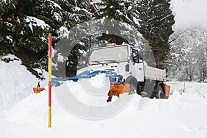 Snow plough making its way through the snow photo