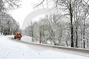 Snow ploughing truck cleans the road